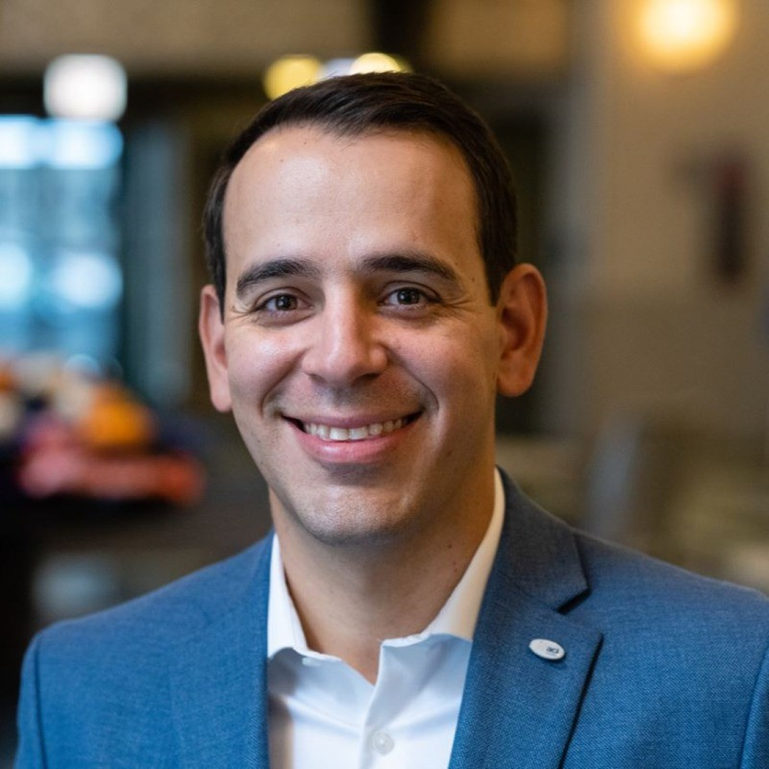 professional shot of Tim in front of office background