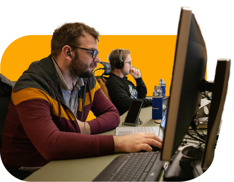 people using computers on yellow background