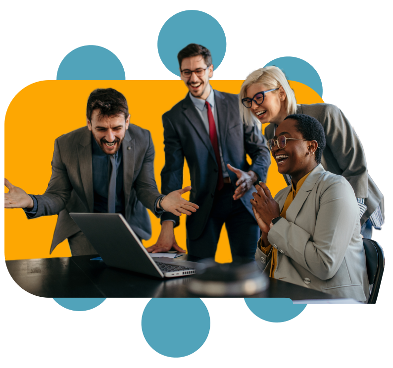 excited coworkers in business attire huddled around computer